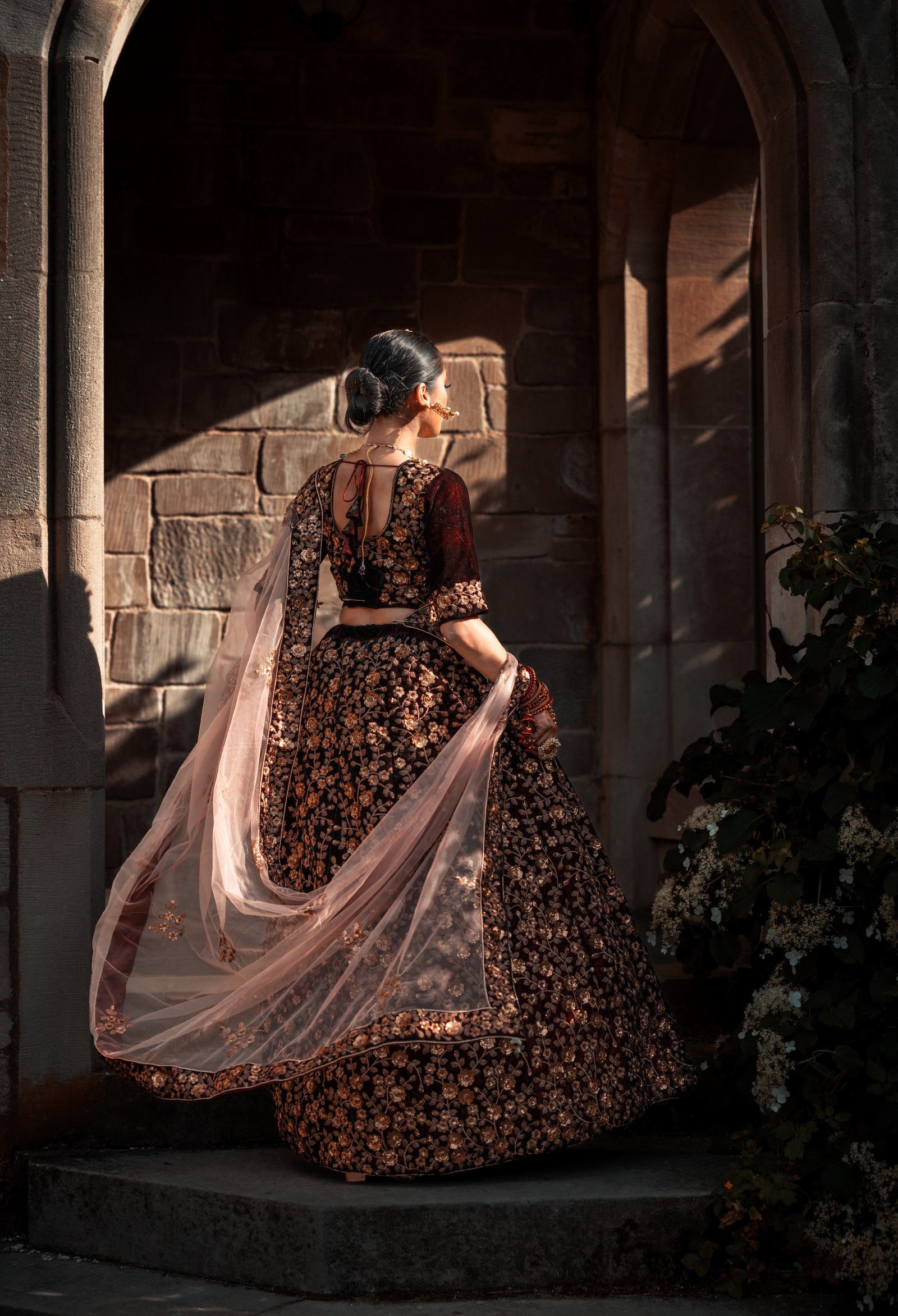 Cinematic back-view bridal portrait arch — The Gotham Studio
